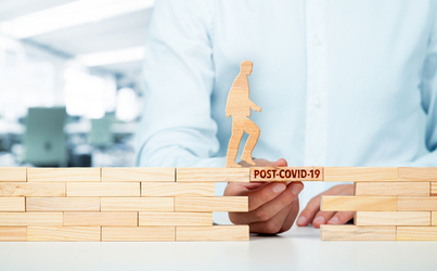 A man holding a wooden brick