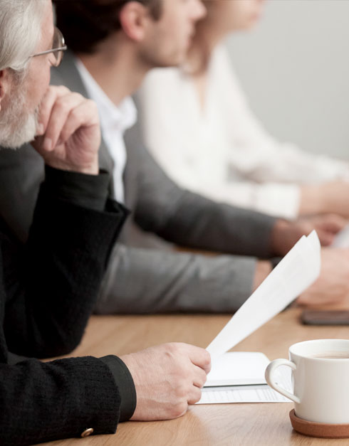 Man Holding Paper in a Meeting