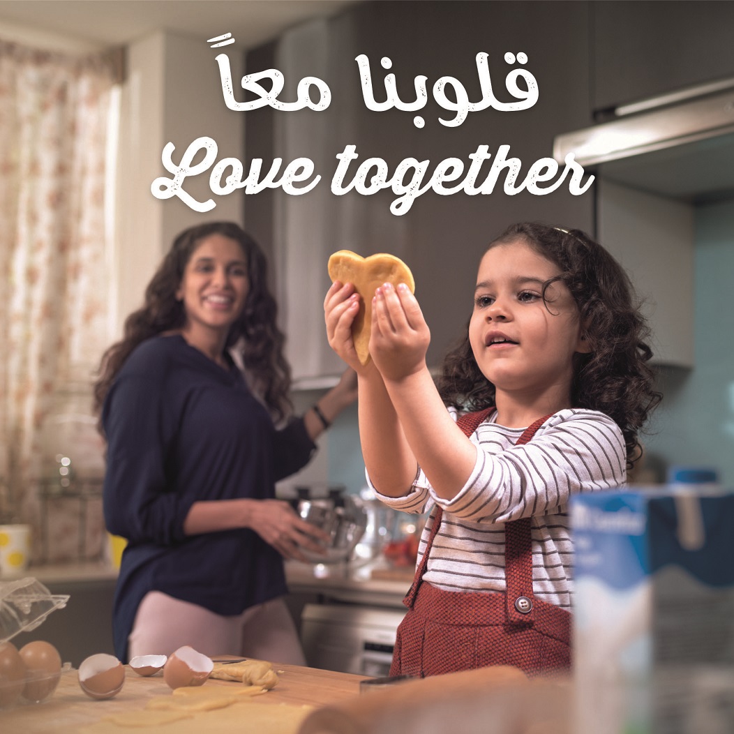 a girl baking with her mom