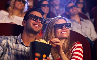 a couple enjoys a film with popcorn